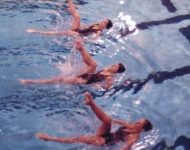 three Swarthmore synchronized swimmers performing in the pool